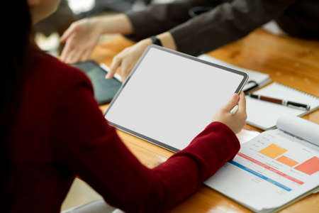 Cropped, Business female boss using digital tablet in business meeting, tablet blank screen mockup for montage your graphic.の写真素材