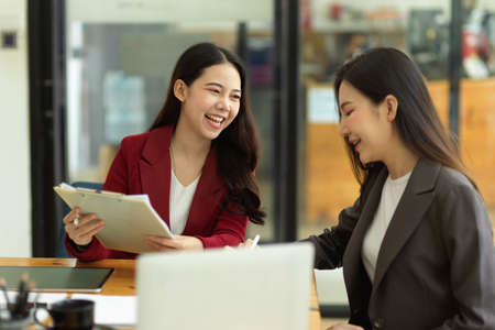 Happy and cheerful colleagues working and planning new business model together in the office, Good business work conversationの写真素材