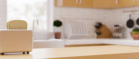 Modern luxury wooden kitchen countertop with toaster and space for montage over blurred furnished home kitchen interior in background. 3d rendering, 3d illustrationの写真素材