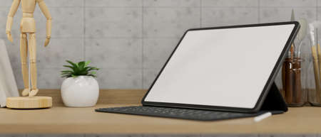 Close-up A modern tablet computer with a white screen mockup stands on a wooden table with decor in a home workspace. 3d illustration, 3d renderingの写真素材