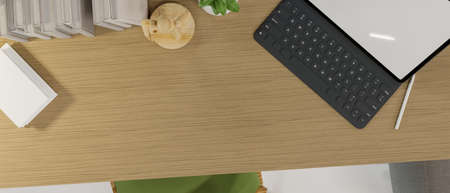 Top view of Simple workspace with modern tablet computer mockup, books, decor and copy space on wooden table. 3d rendering, 3d illustrationの写真素材