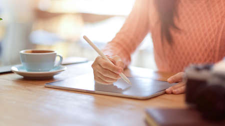 Cropped, closeup image of female college student doing homework, online learning, make a lecture on...