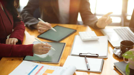 Two of asian businesswomen discussing an interesting business idea and planning business model in modern officeの写真素材
