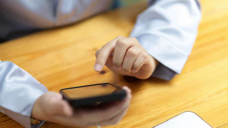 Close-up Adult female using modern smart mobile phone to shopping online, ordering food, transfering money.の写真素材
