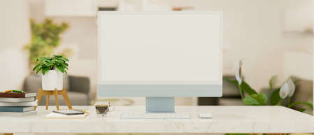 Close-up computer desk with blue computer blank screen mockup for montage your graphic, modern decor, 3d rendering, 3d illustrationの写真素材
