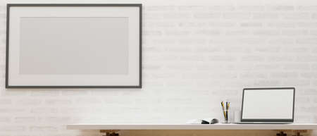 Closeup, Modern home working space with laptop blank screen and copy space on table, poster frame...