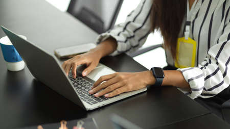 Cropped image of a smart business employee in the customer relationship team on a laptop computer replying to client emails.の写真素材