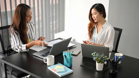 Successful and elegant female business entrepreneur having a meeting with project manager in board roomの写真素材