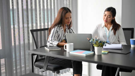 Young business female entrepreneur consult and make the deal with investment female agent in board room. businesswomen working in meeting room.の写真素材