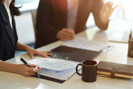 Cropped shot of Male boss talk and discuss business plan with smart female financial broker in the office.の写真素材