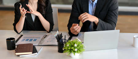 Cropped shot of Male boss consulting with female project manager in meeting room. businesswoman talking with male financial broker.の写真素材