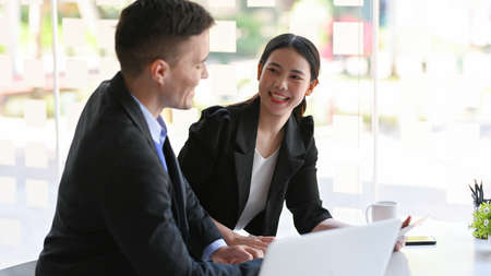 Happy business colleagues having a great time and a lots of fun conversations during work discussionの写真素材