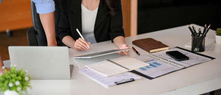 Cropped shot of male boss and female executive manager consult business strategy in their workplace.の写真素材