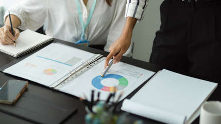 Crop shot of Financial report paperworks, financial informations sheet, investment plans on the deskの写真素材