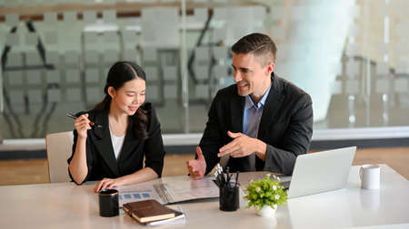 Handsome male health insurance broker presenting his health insurance benefits to successful businesswoman.の写真素材