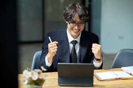 Excited businessman receiving a new job offer email, getting work promotion, getting reward, achievement business goal.の写真素材
