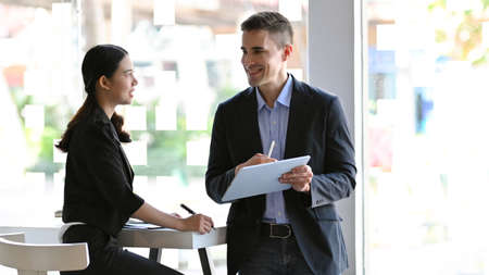 Businessman explain his project idea to manager, female manager giving a work feedback to her staff.の写真素材