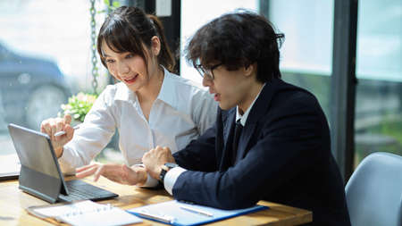 Young asian businessman and businesswoman working and sharing their creative ideas on the project.の写真素材