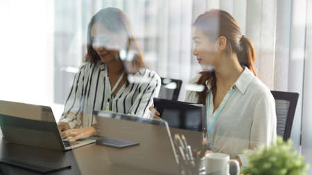 Female accountant worker working and calculating business financial income with her colleagues.の写真素材