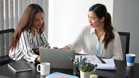 Businesswoman encouraging her colleagues in meeting room. working and planning on business plan.の写真素材