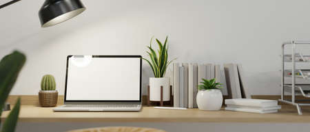 Cozy minimalist computer workspace with laptop computer blank screen mockup and minimal white decor on wooden desk. 3d rendering, 3d illustrationの写真素材