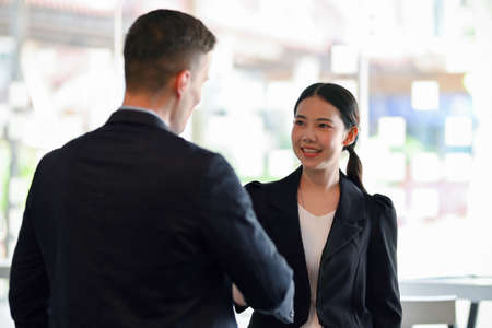 Successful business collaboration meeting partnership shaking hands to greet and congratulate.の写真素材