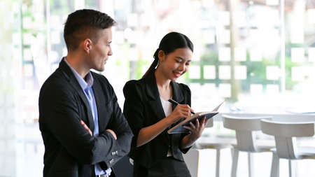 Happy professional business people working and discussing work on digital tablet computer in office.の写真素材