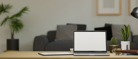 Modern working desk with laptop blank screen mockup and supplies over blurred comfy living room background. 3d rendering, 3d illustrationの写真素材
