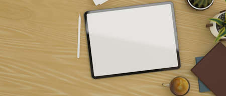 Top view of wooden worktable with digital tablet blank screen mockup for your graphic image. 3d rendering, 3d illustrationの写真素材