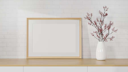 Mockup horizontal wooden picture frame on wood table with minimal flower vase over white brick wall in living room interior. 3d rendering, 3d illustrationの写真素材