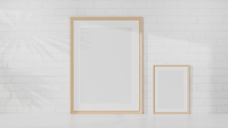 Two different size of minimal wooden picture frame mockup on white table over white brick wall. 3d rendering, 3d illustrationの写真素材
