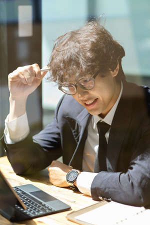 Portrait of Professional male boss sits in the office and works on portable digital tablet computer.の写真素材