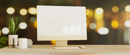 Modern computer blank screen mockup with supplies on wooden table over blurred bokeh light in background. 3d rendering, 3d illustrationの写真素材