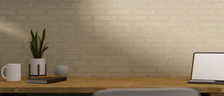 Copy space on simple wooden working table with digital tablet mockup and supplies over brick wall. 3d rendering, 3d illustrationの写真素材