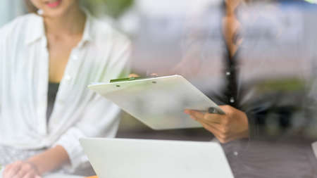 Two of female business employee in a casual dress working together at coffee shop in lunch break.の写真素材