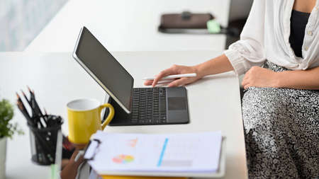 Cropped shot of Charming businesswomen in comfy dress working on her portable wireless tablet computer.の写真素材