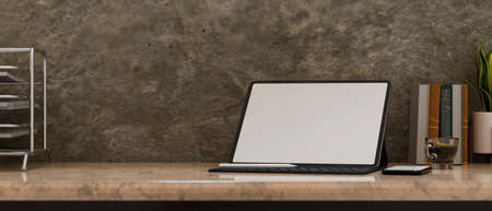 Modern vintage stylish workspace, tablet blank screen mockup and office supplies on marble table over grunge cement loft wall background. 3d rendering, 3d illustrationの写真素材