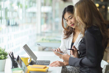 Young asian professional businesswomen discussing the project together in modern office room.の写真素材