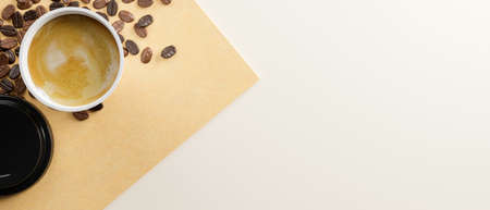 Top view, flat lay image of hot cappuccino in paper coffee cup with coffee beans and copy space for your graphic on white background. 3d rendering, 3d illustrationの写真素材