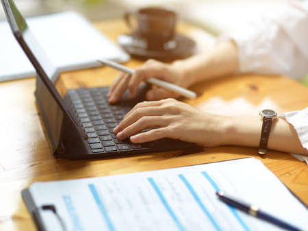 Cropped image of Female doctor working on her digital tablet computer in hospital office.の写真素材