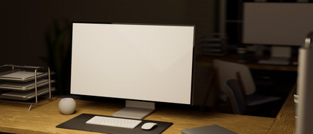 Computer white desktop screen and office supplies on modern workspace in dark work office studio at night. 3d rendering, 3d illsutrationの写真素材