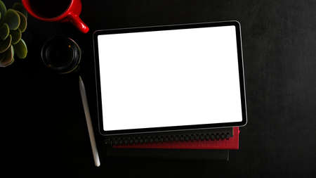 Digital portable wireless tablet computer with white screen display on black background. top view, flat layの写真素材