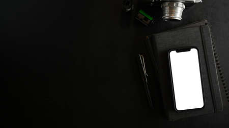 Top view of smartphone with white screen display on black background. top view, flat layの写真素材