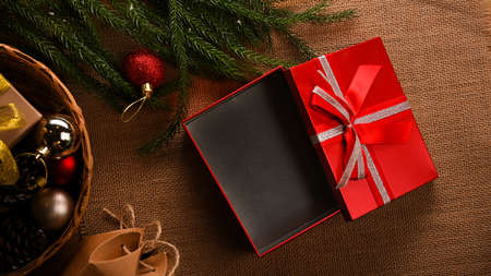 Christmas gift celebrations, gift box with Christmas festive decorations on wooden background. Happy new year. top view, flat layの写真素材