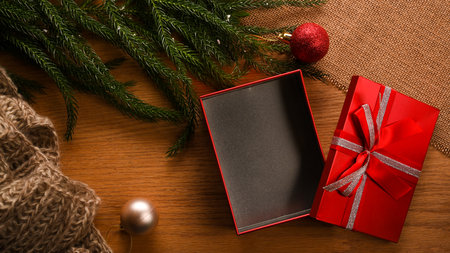Top view of Christmas gift present box and beautiful festive decorations on wooden background. Happy holiday concept. flat layの写真素材