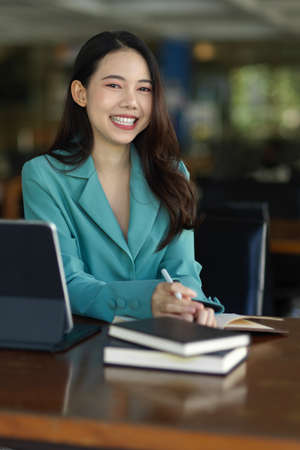 Portrait of a beautiful woman or college student doing research at the library on a topic of interest.の写真素材