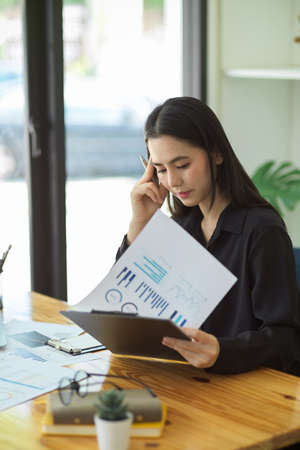 Portrait of a Professional businesswoman pensive thinking on her project at the modern office.の写真素材