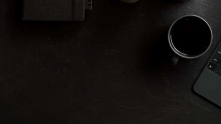 Modern black workspace with copy space for product display with digital tablet computer and coffee cup. top viewの写真素材