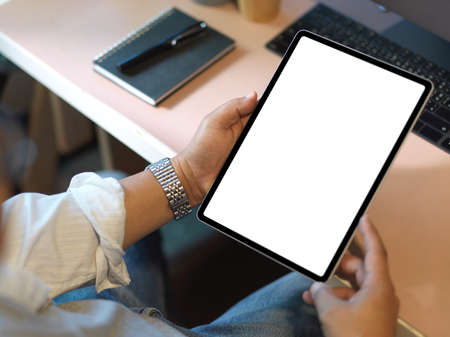 Close-up, A businessman using digital tablet computer at the desk. tablet or touchpad blank display.