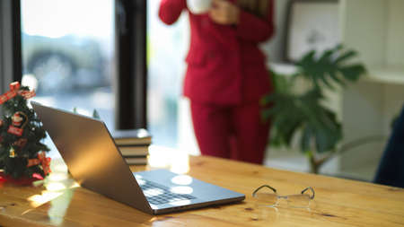 Modern office concept. close-up image of laptop computer on wooden table in businesswomen's office.の写真素材
